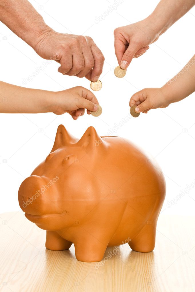Hands of different generations putting coins in piggy bank