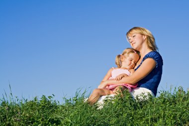 Woman and little girl enjoying sunshine clipart