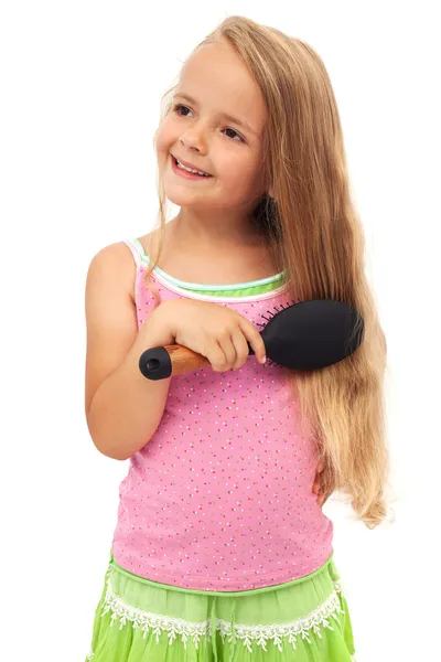 Malá dívka česání vlasů — Stock fotografie