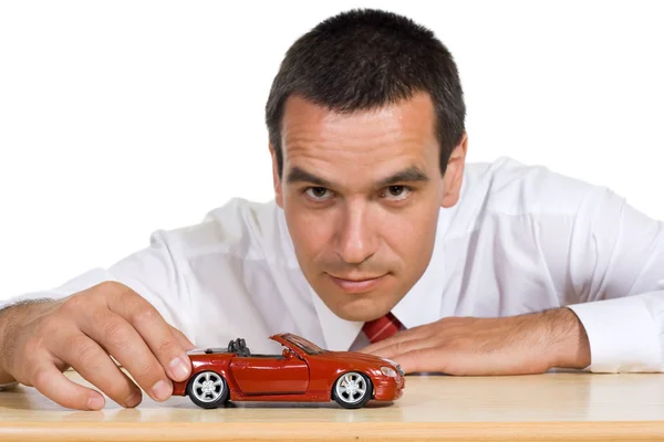 Businessman with toy car - isolated — Stock Photo, Image