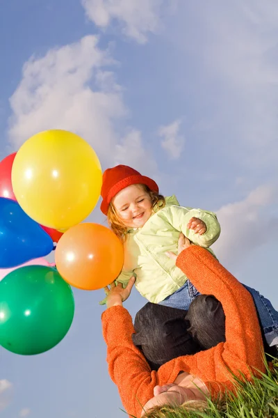 Women and child playing with balloons — Stock Photo, Image