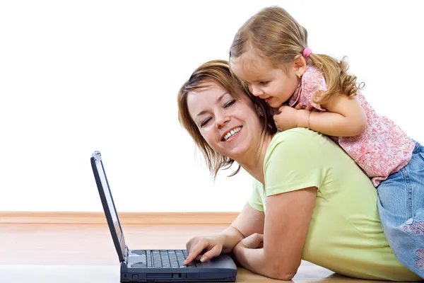 Woman and little girl with laptop — Stock Photo, Image