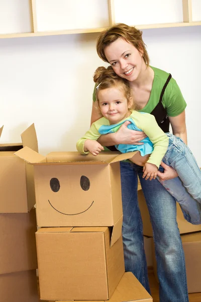 Klein meisje en vrouw met kartonnen dozen — Stockfoto