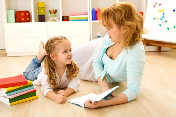 Story time - little girl and woman reading a book — Stock Photo, Image