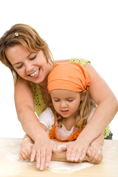 Little girl and woman stretching the dough - making cookies — Stock Photo, Image
