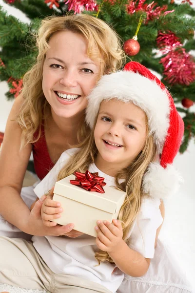 God jul - kvinna och liten flicka med en present — Stockfoto