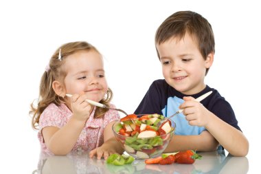 Happy kids eating fruit salad clipart