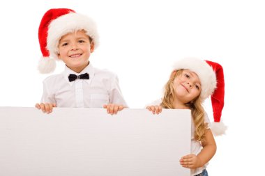 Kids with santa hats and white banner for text clipart