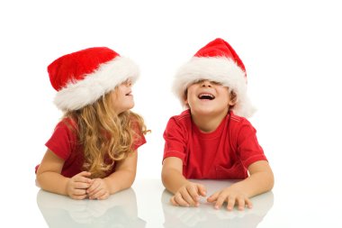 Kids having fun with christmas hats clipart