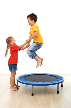 Kids having fun on a trampoline clipart