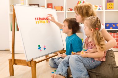 Kids learning the numbers with their mother clipart