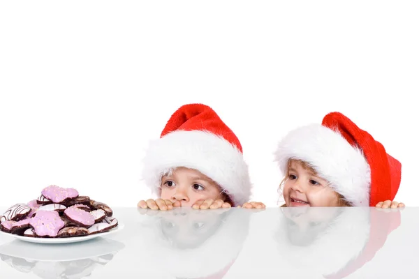 Two kids yearning for the christmas cookies — Stock Photo, Image