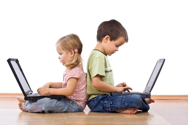 Siblings using laptops — Stock Photo, Image