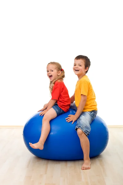 Kids jumping on a large rubber ball — Stock Photo, Image