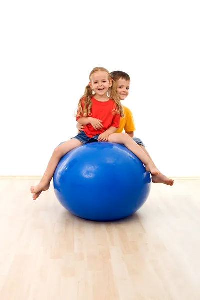 Kids having fun and exercises with a large ball — Stock Photo, Image