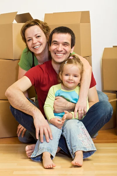 Família feliz em sua nova casa com muitas caixas — Fotografia de Stock