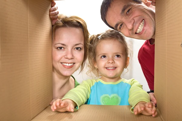 Счастливая семья смотрит в картонную коробку — стоковое фото