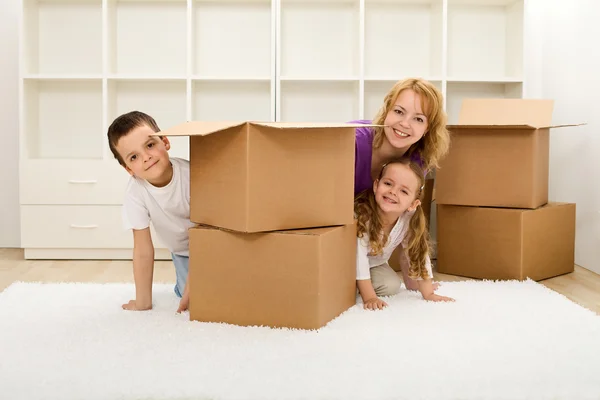 Happy kids and woman in a new home — Stock Photo, Image