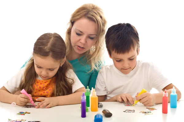 Kids busy painting with lots of colors — Stock Photo, Image
