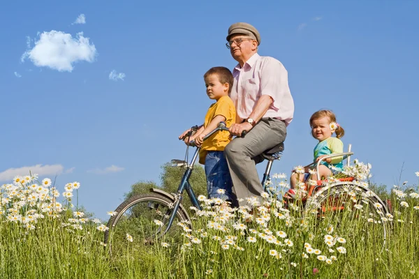 Riding with grandpa on a bike — Stock Photo, Image