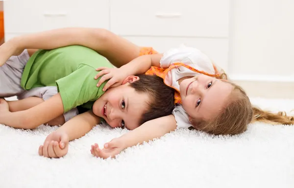Happy kids wrestling in their room Stock Image