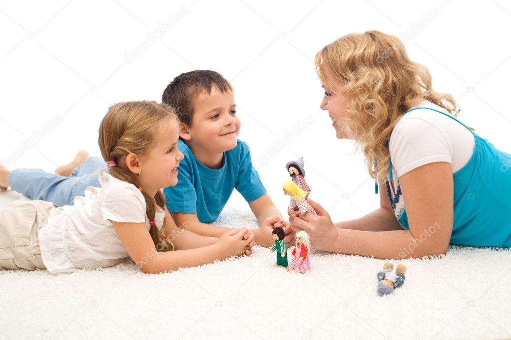 Woman telling a story to her kids on the floor