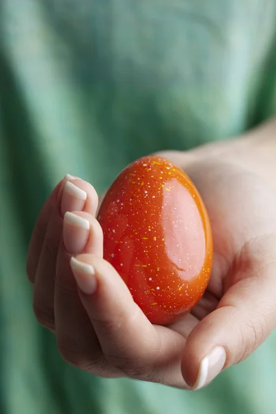 stock image Female hand holding a red easter egg