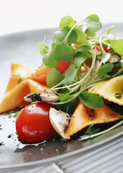 Салат из макарон с помидорами, роккой, грибами, травами — стоковое фото