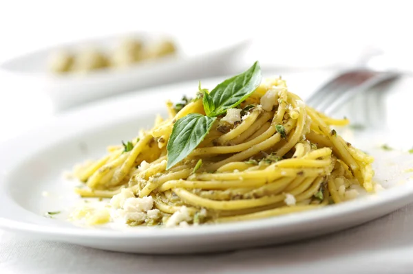 Spaghetti with pesto sauce and cheese — Stock Photo, Image