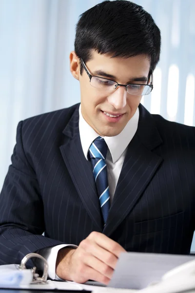 Successful businessman with documents at office — Stock Photo, Image