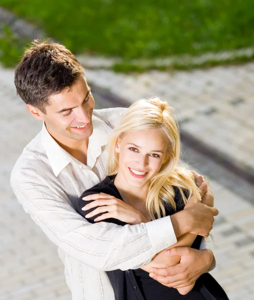 Young happy embracing couple, outdoors — Stock Photo, Image