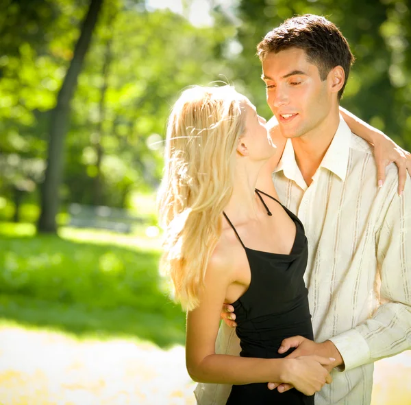 Portrait of young happy attractive embracing couple, outdoors — Stock Photo, Image