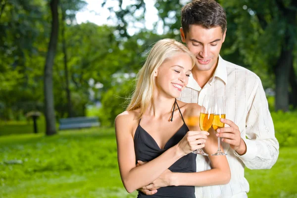 Young happy couple celebrating with champagne, outdoors — Stock Photo, Image