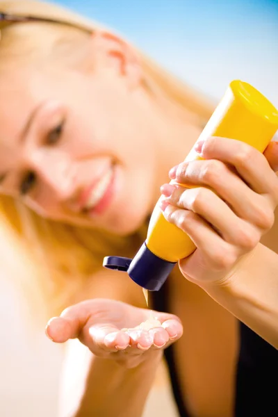 Young beautiful smiling woman with sun-protection cream on the b — Stock Photo, Image