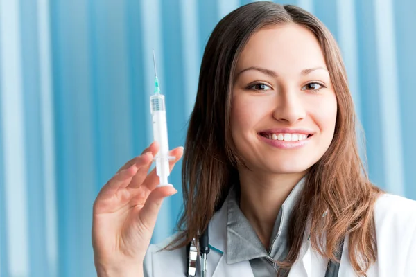 Glad kvinnliga läkare med spruta på kontor — Stockfoto