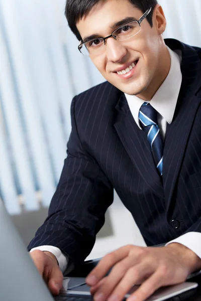 Successful businessman with laptop at office Stock Picture
