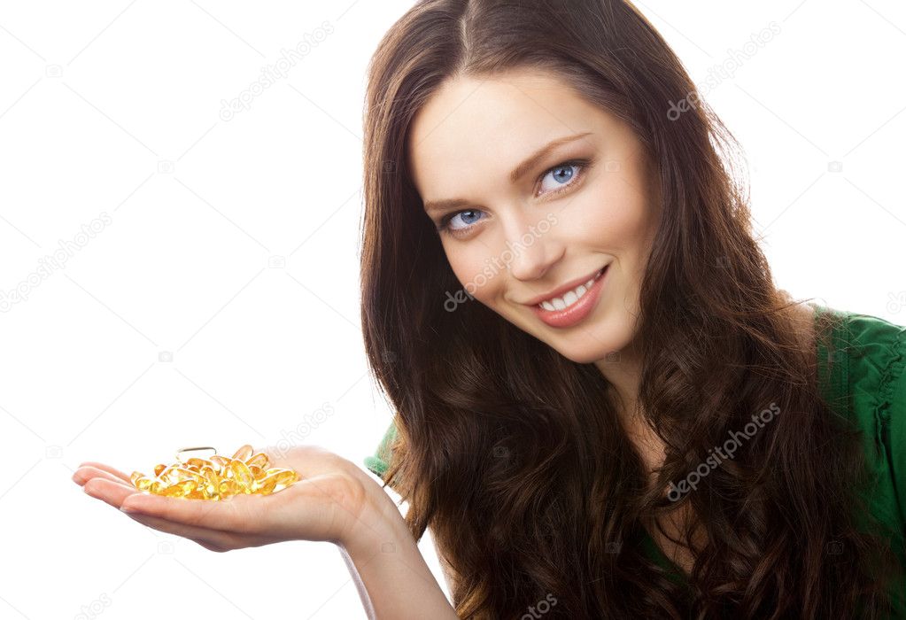 Portrait of woman showing Omega 3 fish oil capsules, isolated on