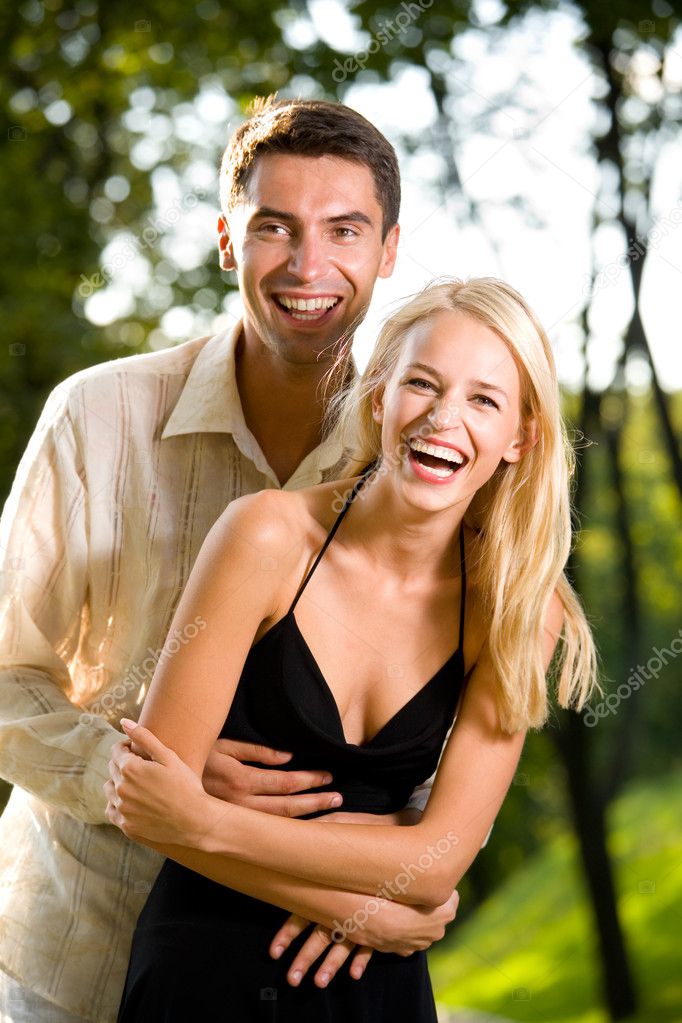 Young happy attractive couple walking outdoors together