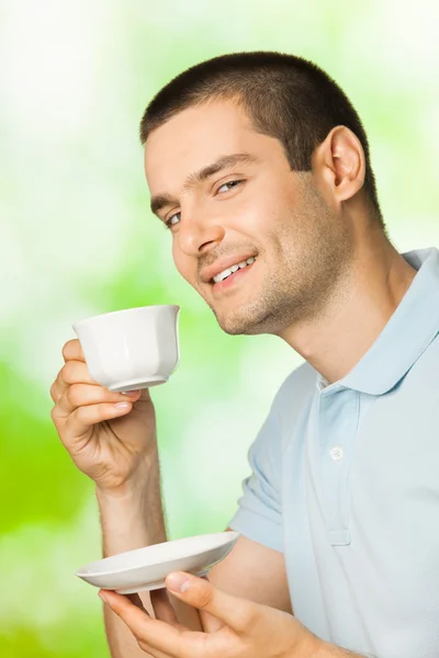 stock image Portrait of young happy smiling man drinking coffee, outdoors