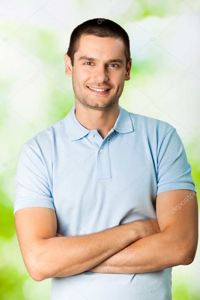 Portrait of young attractive smiling man, outdoors