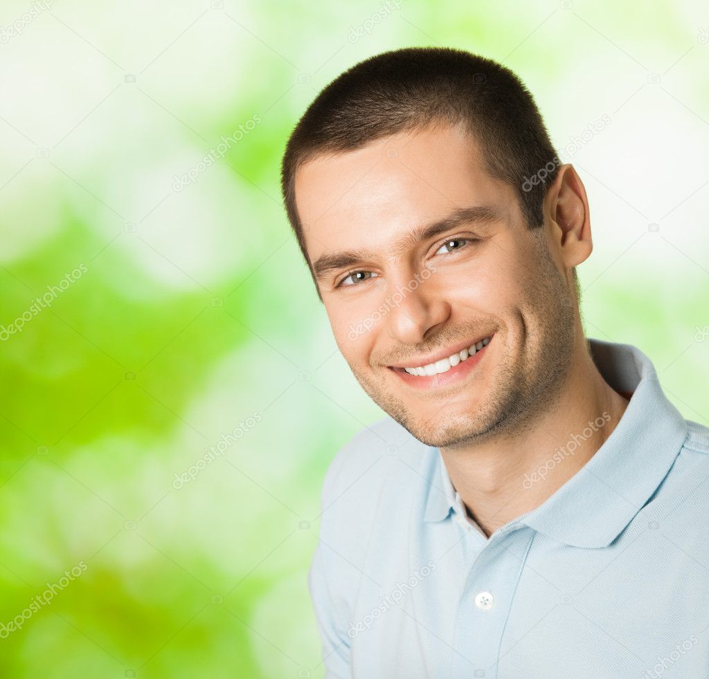 Portrait of young happy smiling attractive man, outdoors