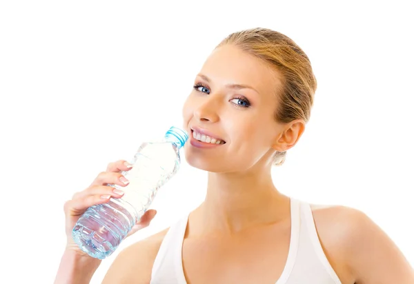 Женщина в спортивной одежде питьевая вода, изолированная на белом Лицензионные Стоковые Изображения