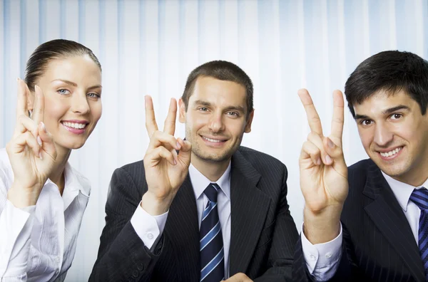 Happy successful gesturing businesspeople at office — Stock Photo, Image