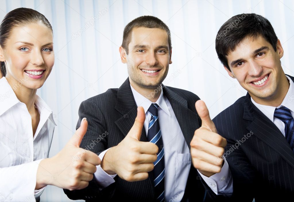 Happy successful gesturing businesspeople at office
