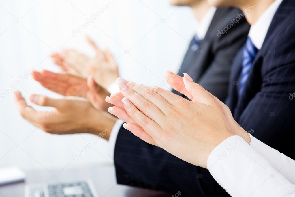 Close up clapping hands of businesspeople at presentation, meeti