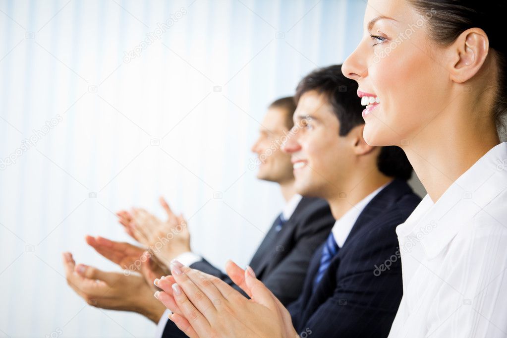Three happy clapping businesspeople at presentation, meeting, se