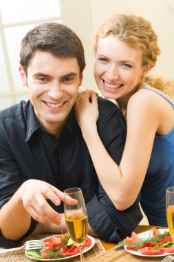 Young couple celebrating with champagne at home clipart