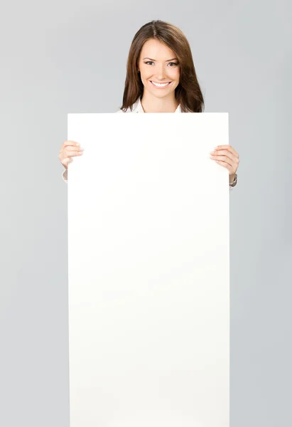 Businesswoman showing signboard, over grey — Stock Photo, Image