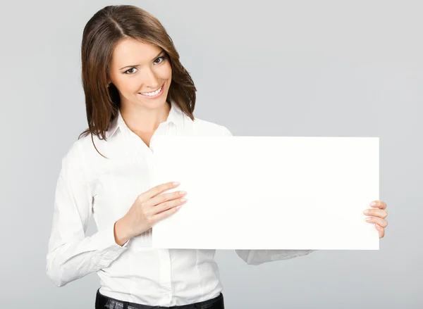 Businesswoman showing signboard, over grey Royalty Free Stock Photos