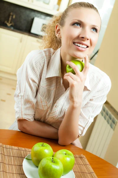 Young happy smiling woman with apples, at home — Stock Photo, Image